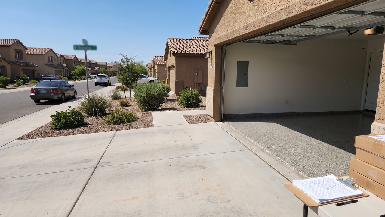 Epoxy garage floor Phoenix HOA community homeowner reviewing architectural approval paperwork